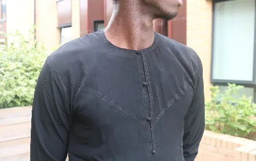 A man in a black emirati thobe