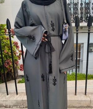 A woman wearing a dark grey lina abaya