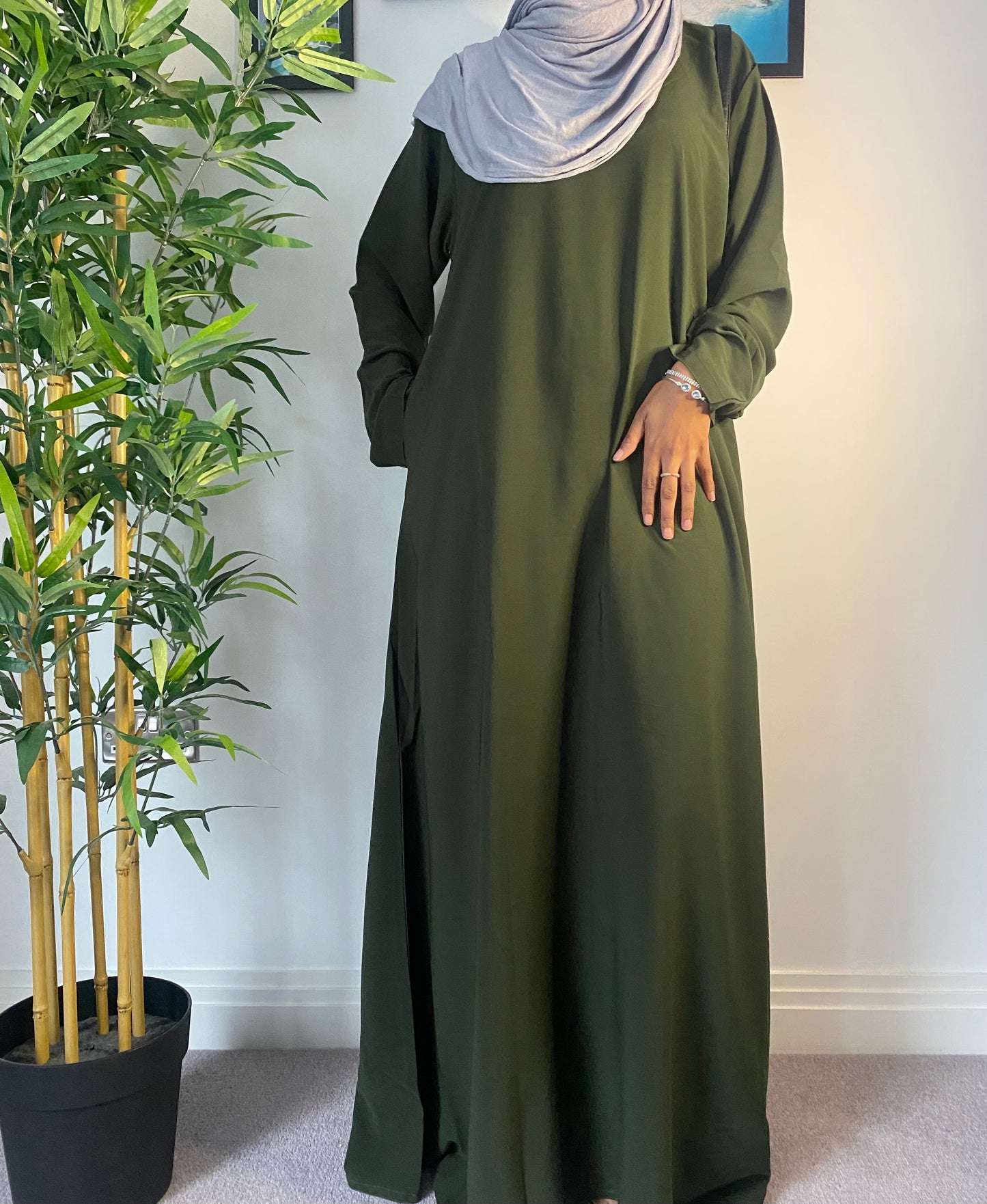 A woman wearing a simple forest green abaya