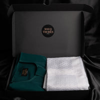 A package containing an emerald green emirati thobe and imaamad white scarf
