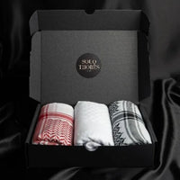 A package containing an imaamad, red and white scarf, white scarf and black and white scarf