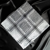 An imamaad black and white scarf folded