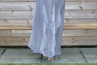 A woman wearing a light blue steel inayah abaya