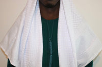 A man wearing an imaamad white scarf