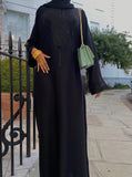 A woman wearing a black jamila abaya