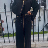 A woman wearing a black jazmin abaya