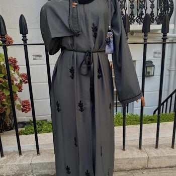 A woman wearing a  dark grey lina abaya